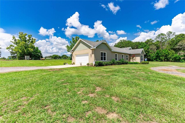 view of front of property featuring a garage and a front lawn