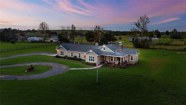 view of front of property featuring a lawn and a porch