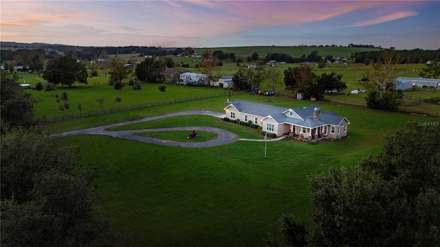 aerial view at dusk featuring a rural view