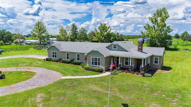 ranch-style house with covered porch and a front yard