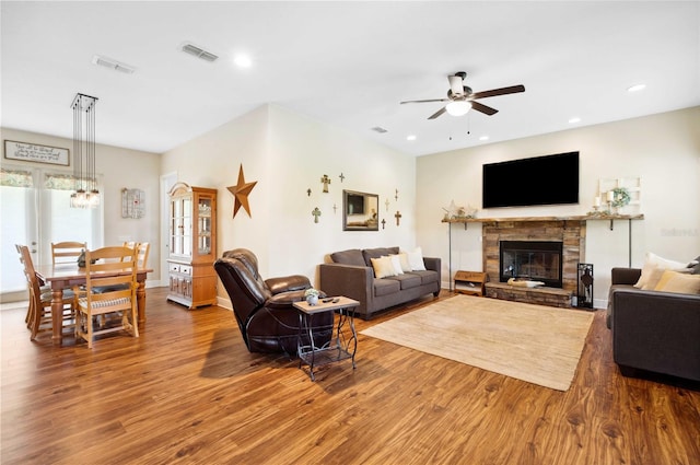 living room with a fireplace, hardwood / wood-style flooring, and ceiling fan