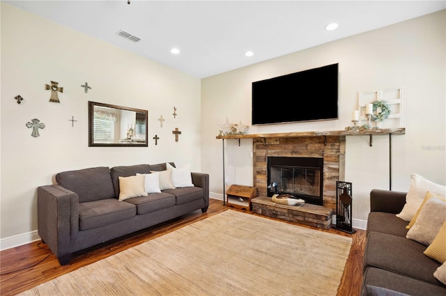 living room with wood-type flooring and a fireplace