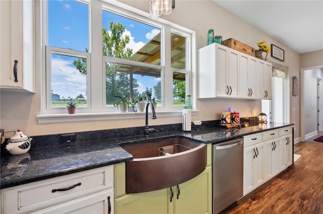 kitchen with stainless steel dishwasher, plenty of natural light, sink, and white cabinetry