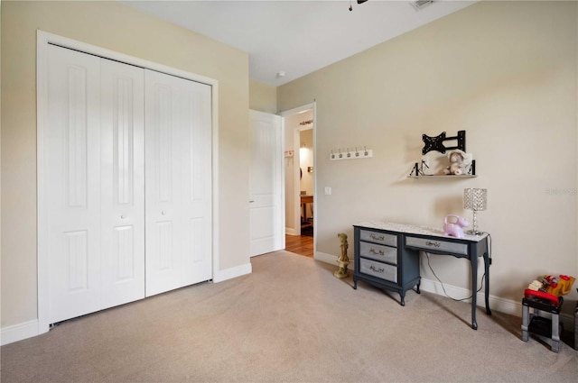 interior space with light colored carpet and a closet