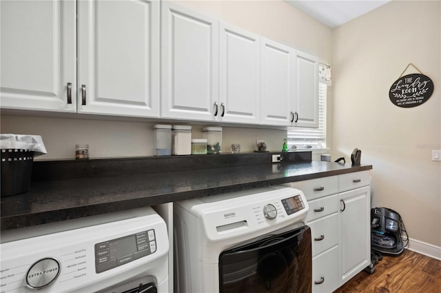 washroom featuring cabinets, separate washer and dryer, and dark hardwood / wood-style floors