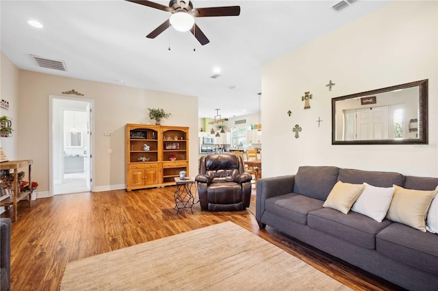 living room featuring hardwood / wood-style floors and ceiling fan