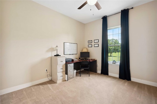 carpeted office space featuring ceiling fan