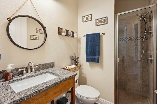 bathroom with walk in shower, vanity, and toilet