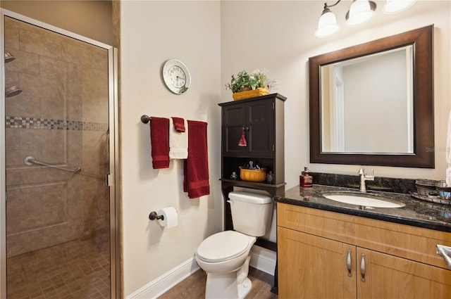 bathroom with walk in shower, vanity, and toilet