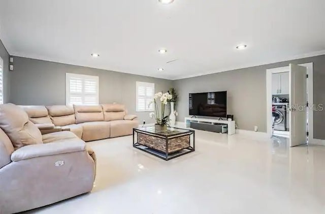 living room featuring concrete floors and washer / clothes dryer