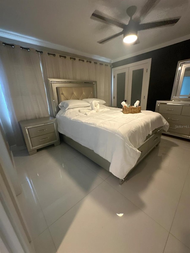 tiled bedroom with crown molding, french doors, and ceiling fan