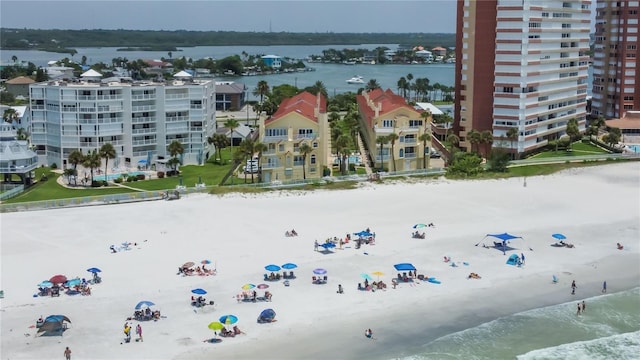 bird's eye view featuring a water view and a beach view