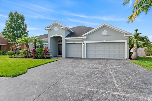 ranch-style house with a garage and a front yard