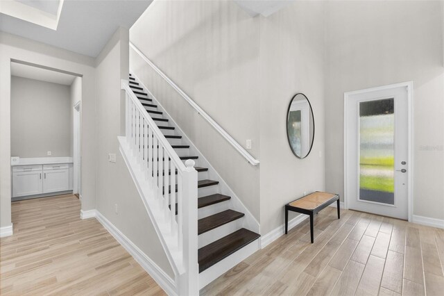 stairs featuring hardwood / wood-style floors