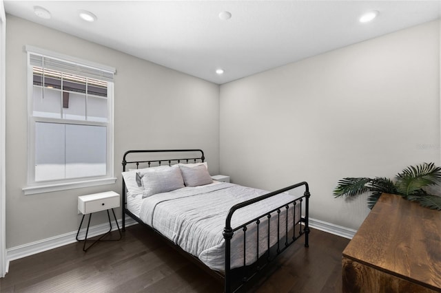 bedroom with dark hardwood / wood-style floors