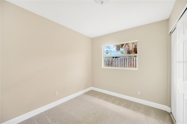 spare room with carpet flooring and baseboards