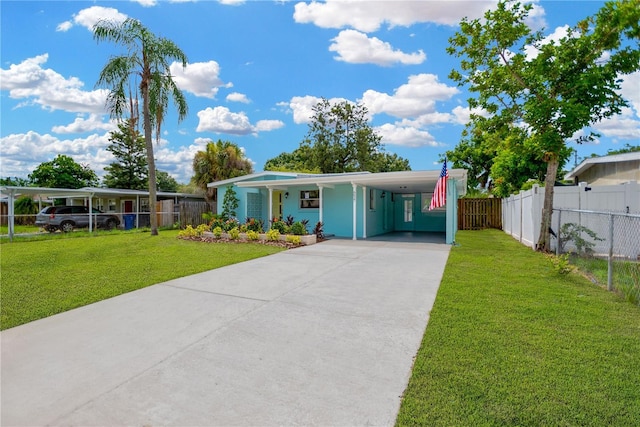 view of front of property featuring driveway, fence, a front lawn, and a carport