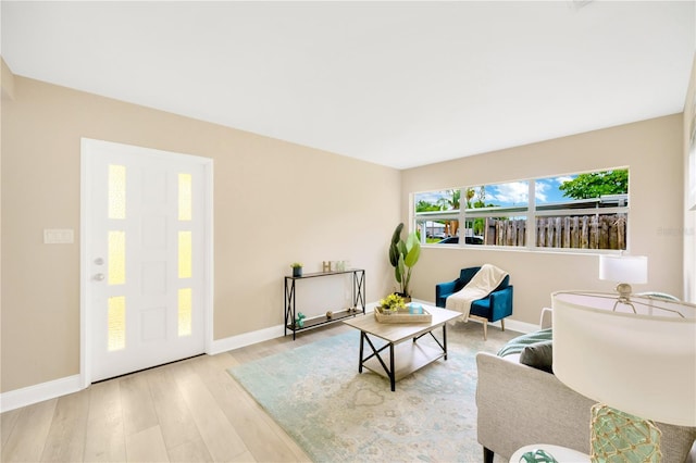 living area with baseboards and light wood-style floors