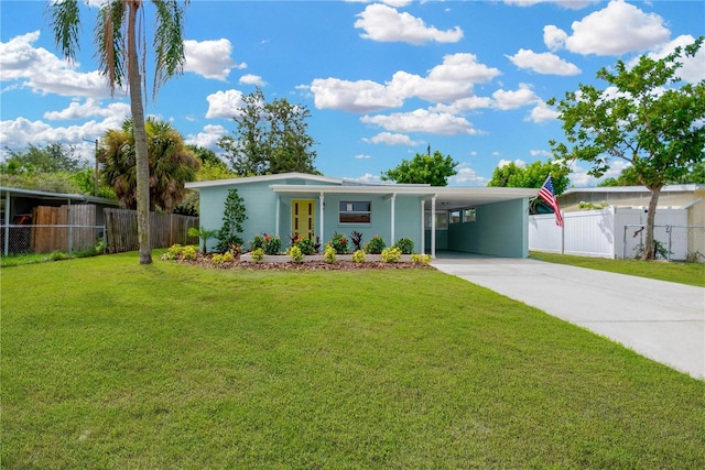 mid-century inspired home featuring a carport, fence, concrete driveway, and a front yard