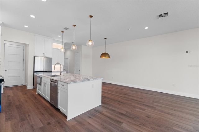 kitchen with dark hardwood / wood-style flooring, a kitchen island with sink, sink, and white cabinets