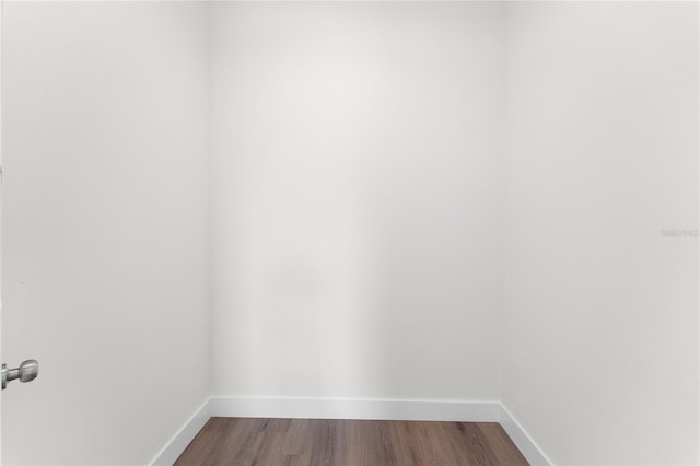 interior space featuring dark wood-type flooring and baseboards