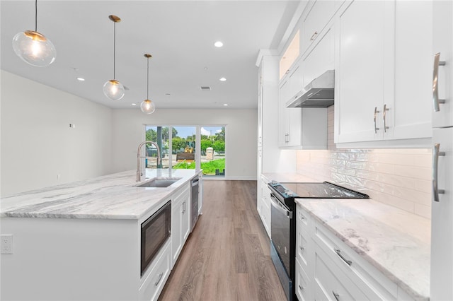 kitchen with decorative backsplash, a sink, black range with electric cooktop, dishwasher, and wall chimney exhaust hood