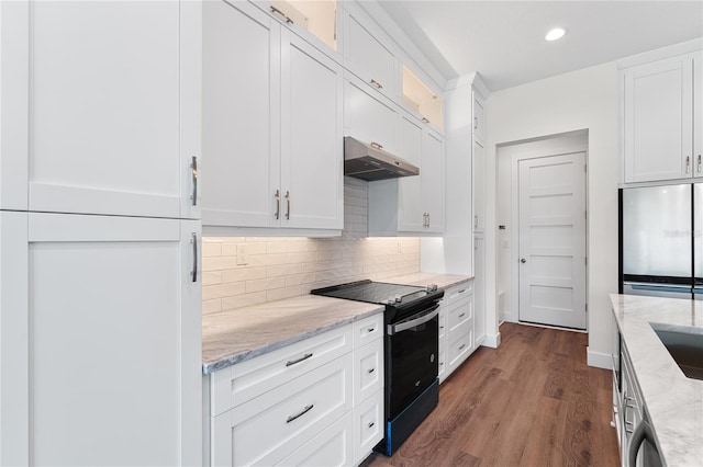 kitchen with stainless steel refrigerator, white cabinetry, light stone countertops, black range with electric cooktop, and hardwood / wood-style floors