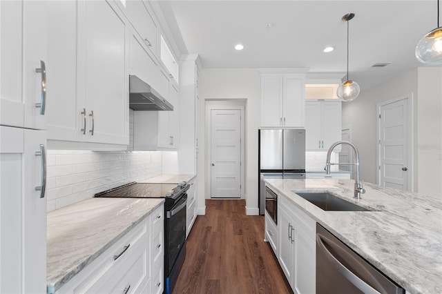 kitchen with visible vents, appliances with stainless steel finishes, white cabinetry, a sink, and wall chimney range hood