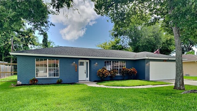 single story home with a garage and a front yard