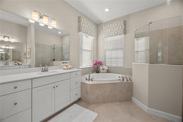 bathroom with vanity, plus walk in shower, and tile patterned flooring