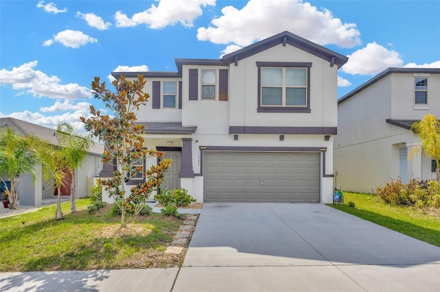 view of front of home with a garage and a front lawn