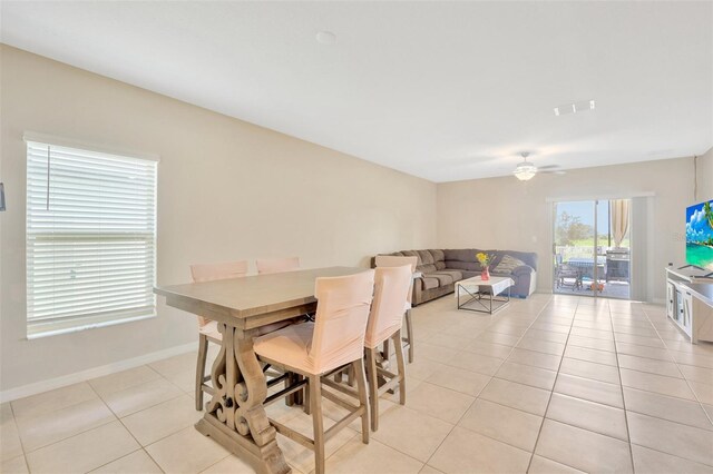 tiled dining room with ceiling fan