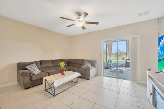 tiled living room with ceiling fan