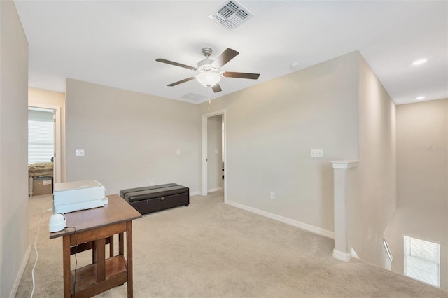 interior space featuring light carpet and ceiling fan