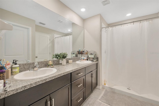 bathroom featuring a shower with shower curtain, vanity, and tile patterned flooring