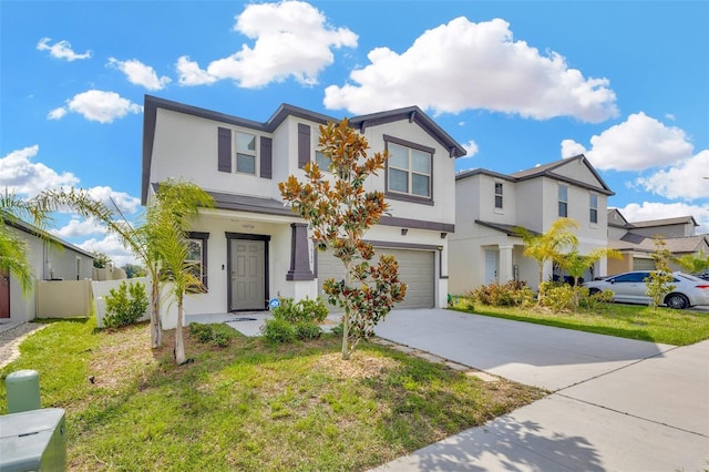 townhome / multi-family property featuring a garage and a front yard