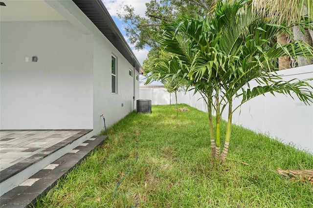 view of yard featuring a fenced backyard and central air condition unit