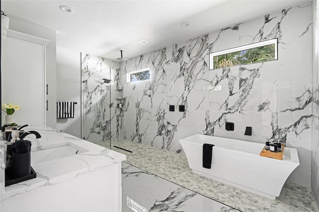 full bathroom with a textured ceiling, recessed lighting, marble finish floor, a soaking tub, and a marble finish shower