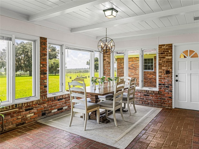 sunroom / solarium featuring a notable chandelier and beamed ceiling