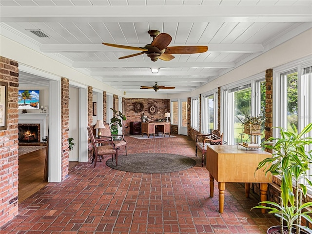 sunroom featuring beam ceiling, a brick fireplace, and wooden ceiling