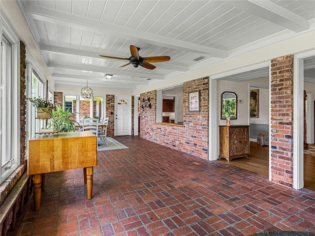 unfurnished sunroom with ceiling fan with notable chandelier and beam ceiling