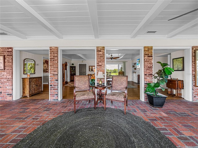 sunroom featuring beam ceiling and decorative columns