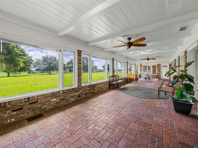 sunroom featuring beam ceiling