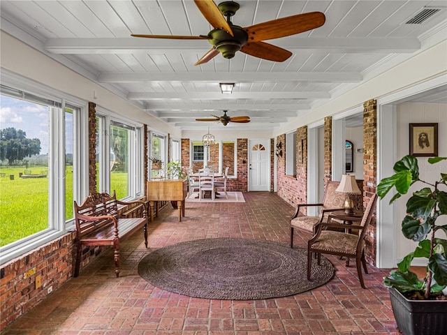 sunroom / solarium featuring ceiling fan, wood ceiling, and beamed ceiling