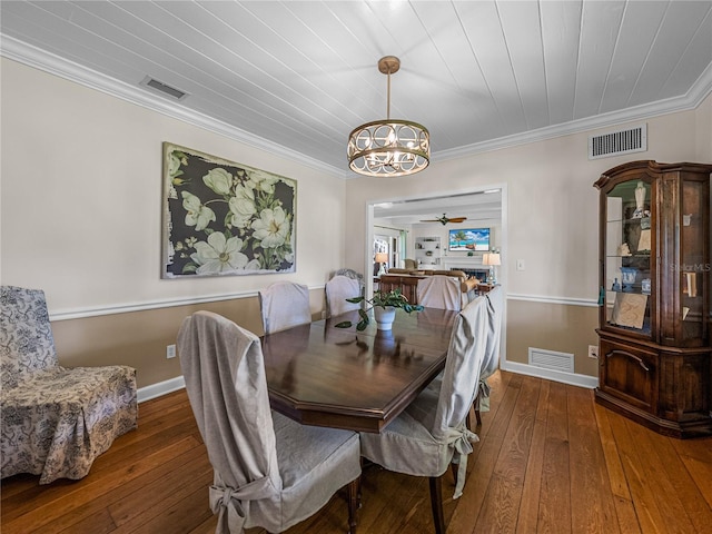 dining room featuring hardwood / wood-style flooring, wooden ceiling, crown molding, and an inviting chandelier