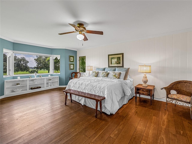 bedroom with ceiling fan, wood-type flooring, and ornamental molding