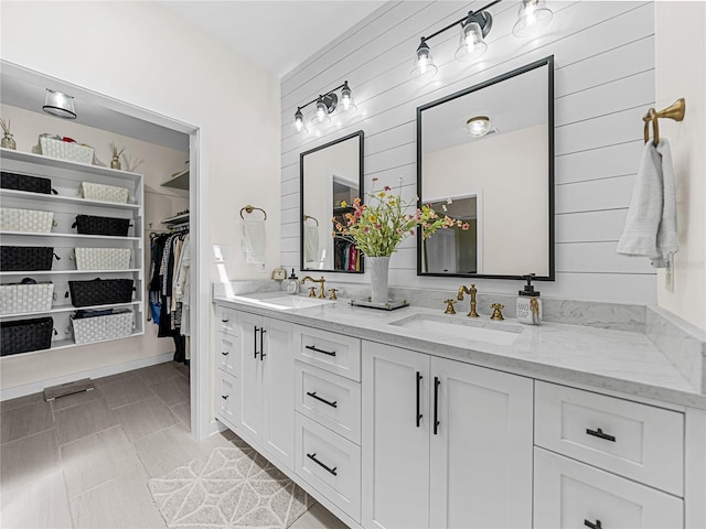 bathroom with vanity and wood walls