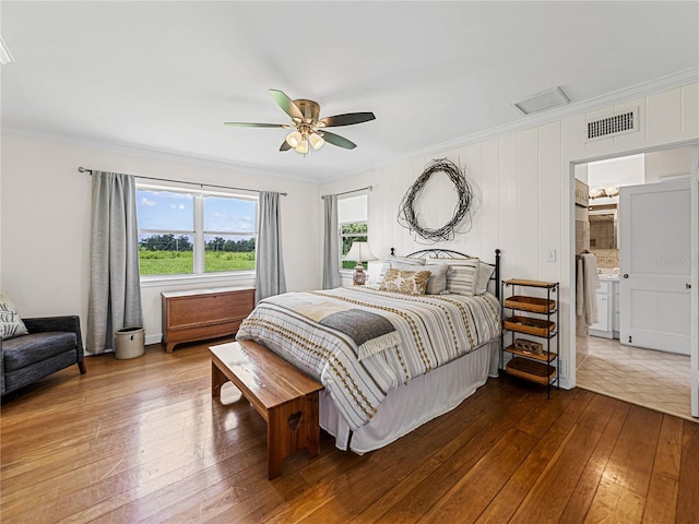 bedroom with ceiling fan, ornamental molding, hardwood / wood-style flooring, and ensuite bath