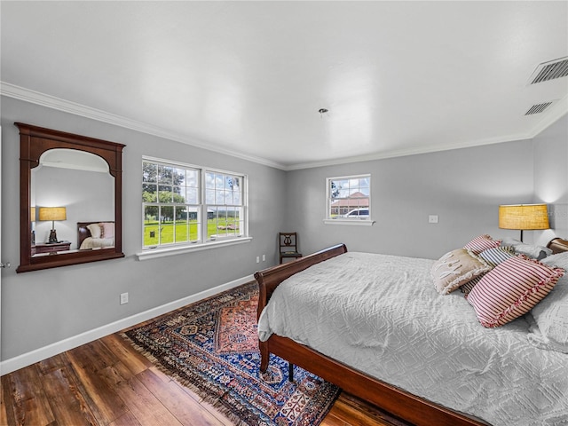 bedroom featuring ornamental molding and hardwood / wood-style flooring