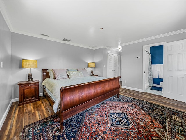 bedroom with ensuite bath, a closet, crown molding, and hardwood / wood-style floors